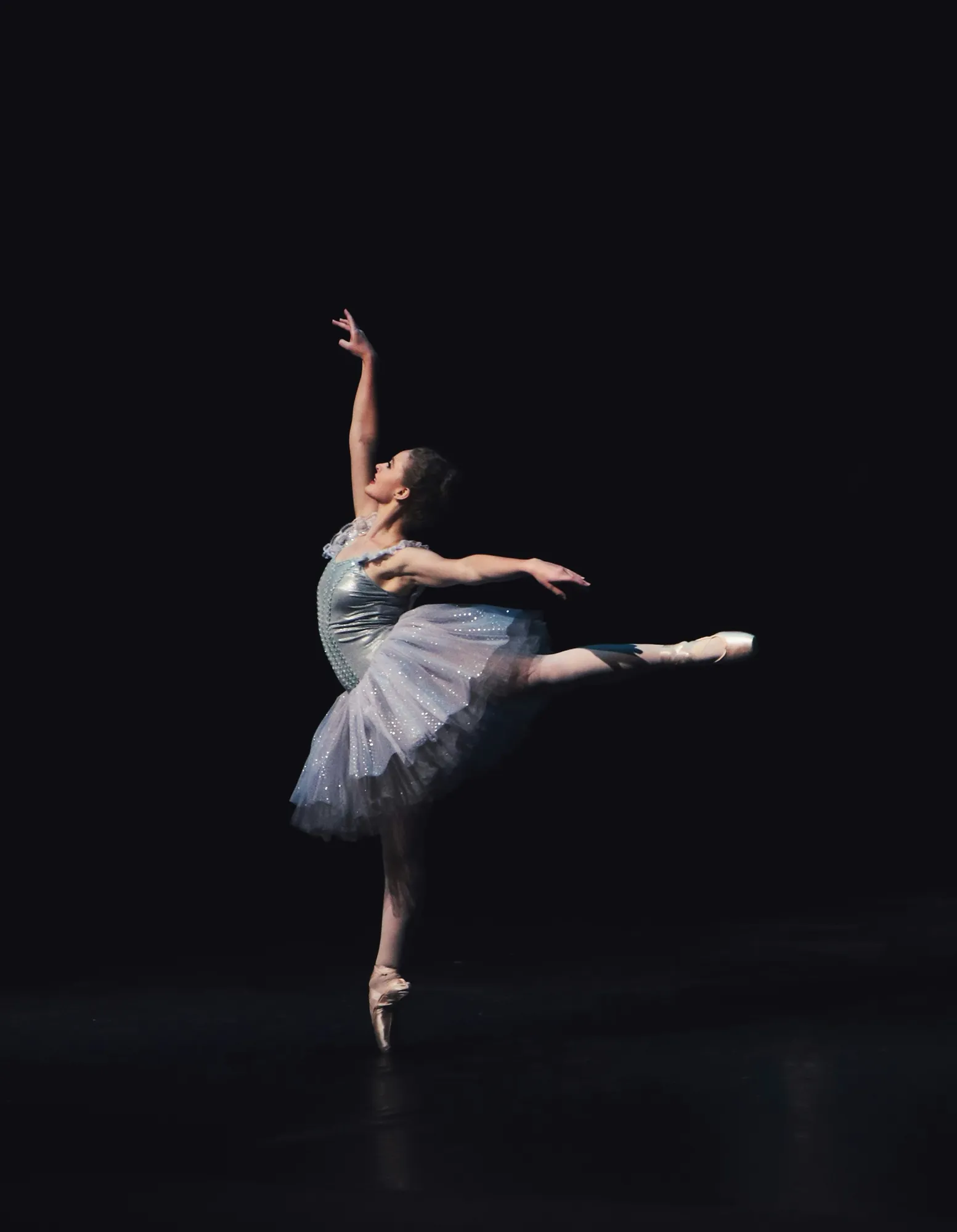 Dancer performing a classical variation on stage.